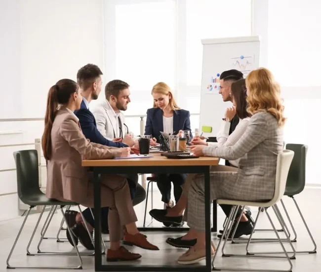 Business consultants collaborating with clients to develop practical solutions